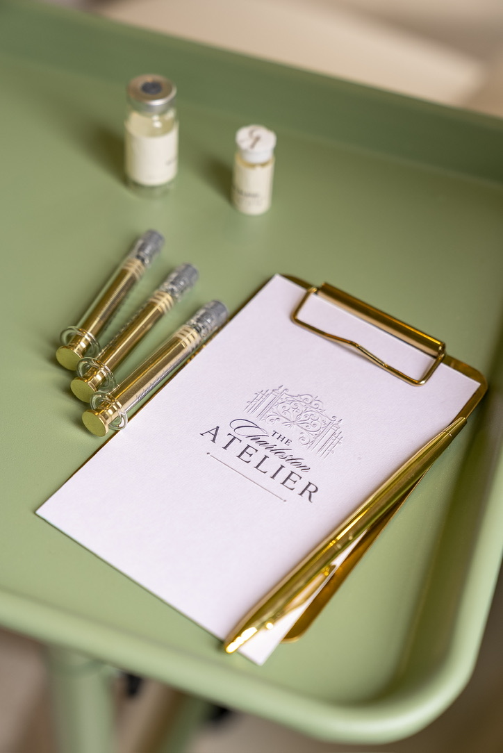 The Charleston Atelier protocol card and gold syringes on a green tray
